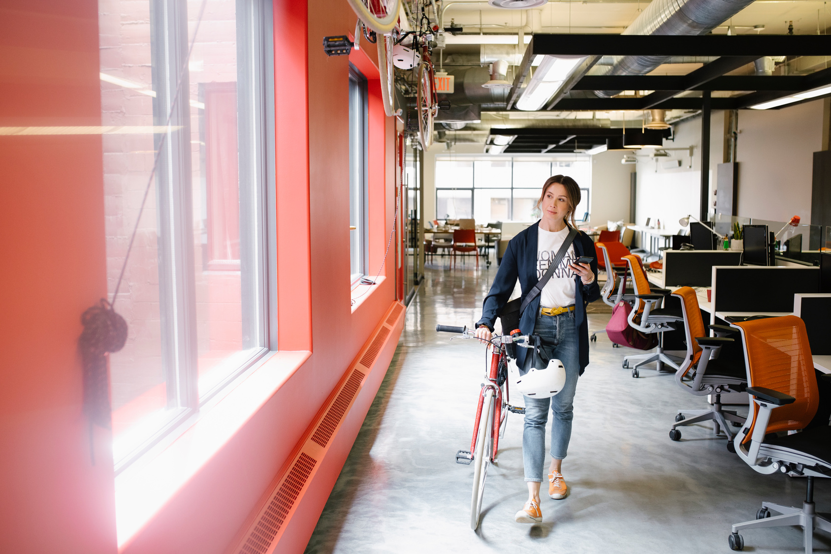 kvinne med sykkel i kontorlandskap